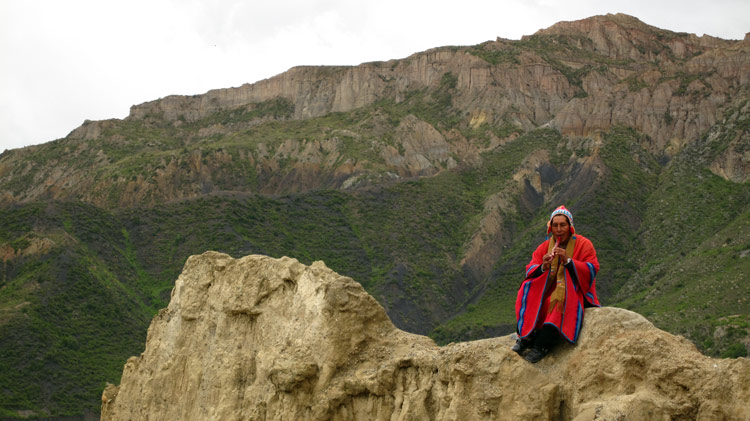Indigenous Aymara playing traditional flute at Valle de la Luna.